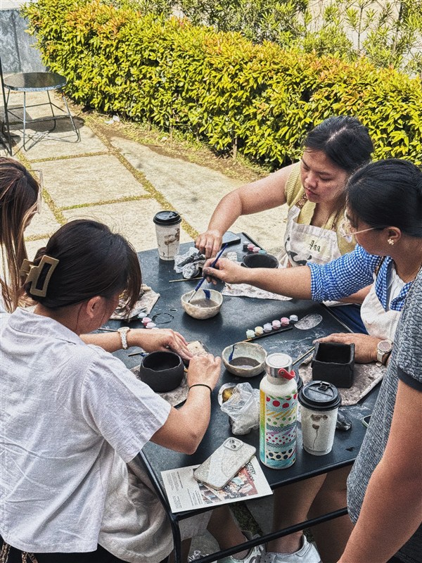 Guests painting pottery at an Afterhours workshop